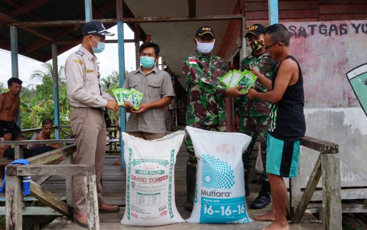 Satgas Pamtas RI-MLY Yonif 407/Padmakusuma Pos Kotis pimpinan Lettu Inf Reiky Martin bersama dengan petugas Karantina Pertanian Wilker Badau, berikan bibit tanaman serta pupuk kepada masyarakat Dusun Klawik, Desa Mensiau, Kecamatan Batang Lupar, Kabupaten Kapuas Hulu. Rabu (30/12/20)