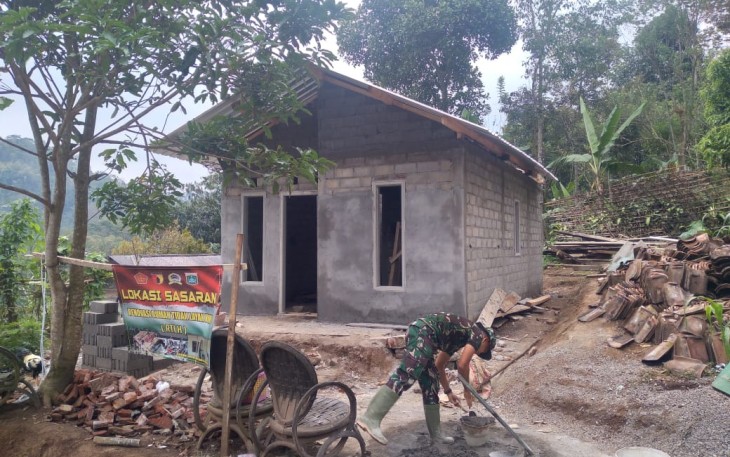 Pak TNI Mengaduk Semen Untuk Bangun Rumah Ibu Sainem