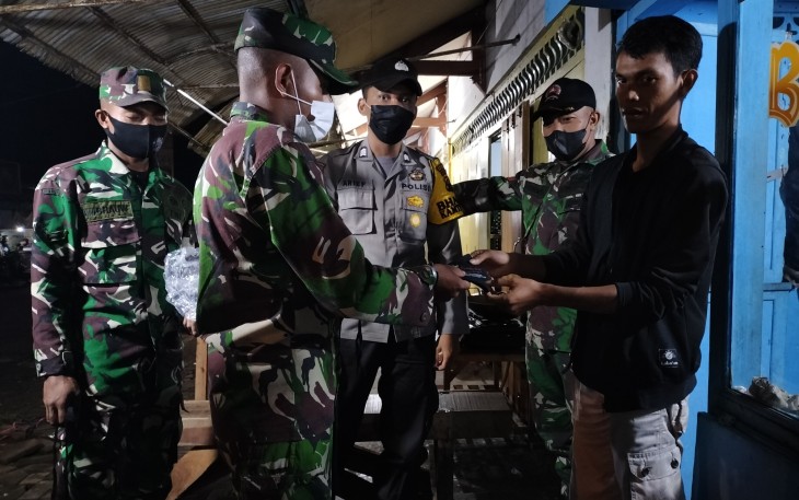 Anggota Koramil 09/Blado Kodim 0736/Batang bagikan masker kepada masyarakat pada Minggu malam