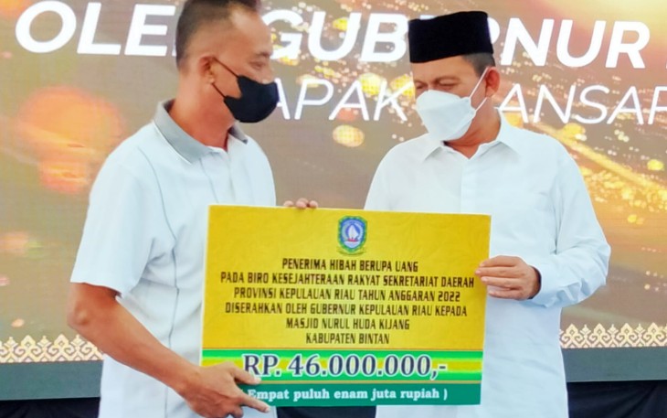Penyerahan secara simbolis dana hibah dari Gubernur Ansar (kanan) ke salah satu penerima
