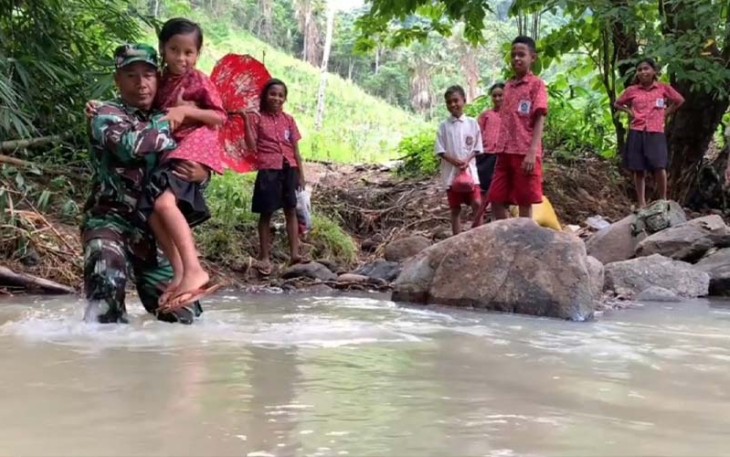 Babinsa di Larantuka saat Bantu Anak Sekolah Seberangi Sungai