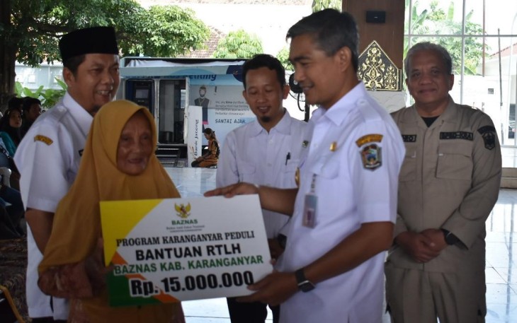 Pj Bupati Karanganyar Timotius Suryadi menyerahkan dana bansos kepada salah satu warga terdampak bencana alam, di Pendopo Rumah Dinas Bupati Karanganyar, Rabu (3/4/2024)