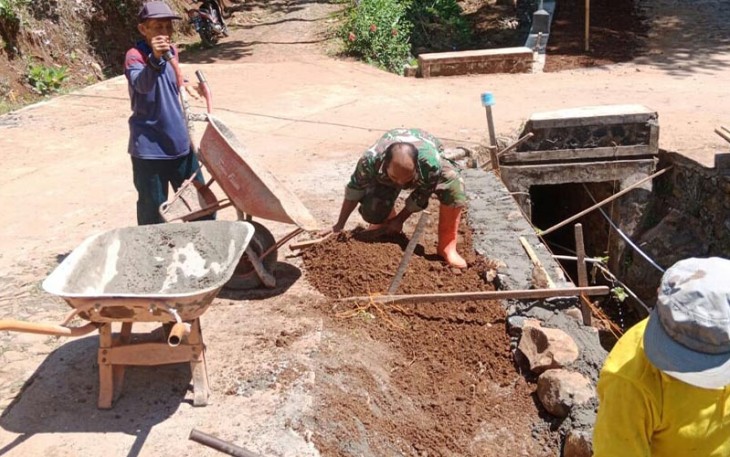 Babinsa Kodim 0802/Ponorogo saat Bantu Warga Bangun Plesengan Jalan