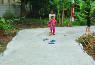 Kegembiraan Kakak Beradik Bermain Skuter di Jalan H. Amin Berkat Program TMMD ke-107
