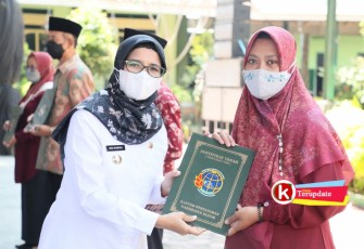 Bupati Rini (kiri) Bagikan Sertipikat PTSL ke Warga Bakung, Udanawu. (foto : Faisal NR / Klikwarta.com)