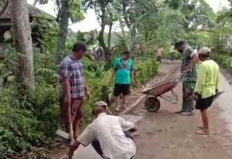 Sertu Edi berjibaku bersama warga pasang paving block