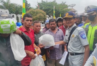 Kepala Perwakilan PT Jasa Raharja Padangsidimpuan, Soni Sumono, Sat Lantas Polres Tapsel, dan lainnya saat berbagi helm gratis ke masyarakat pengguna Jalan