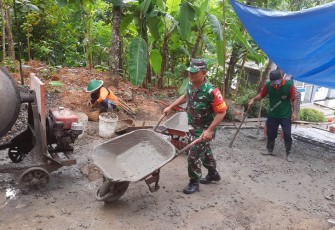 Babinsa Koramil 0801/09 Sudimoro saat Bantu Pembangunan Rabat Jalan