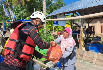 Relawan menyerahkan dukungan sembako kepada warga terdampak bencana di Desa Alur Kapal dan Kelurahan Pematang Cengal, Tanjung Pura, Langkat, Sumatra Utara, Jumat (5/12).