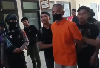 IFR (22), tersangka kasus pembobol brankas gudang PT Marga Nusantara Jaya, saat dibawa aparat kepolisian Polres  Karanganyar, Selasa (7/10/2025).