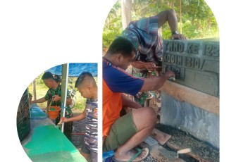Personil Satgas TMMD Ke-123 Kodim 1310Bitung yang tengah melakukan pengecetan dan penulisan prasasti di titik Manunggal Air Kelurahan Girian Indah