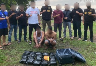 Dua tersangka (tangan diikat) saat diamankan bersama barang bukti 20 Kg Sabu.