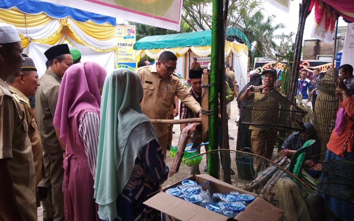 Bupati Aceh Singkil Dulmusrid saat mencoba perasan tebu tradisional dalam Bursa Inovasi Desa Kecamatan Singkil.