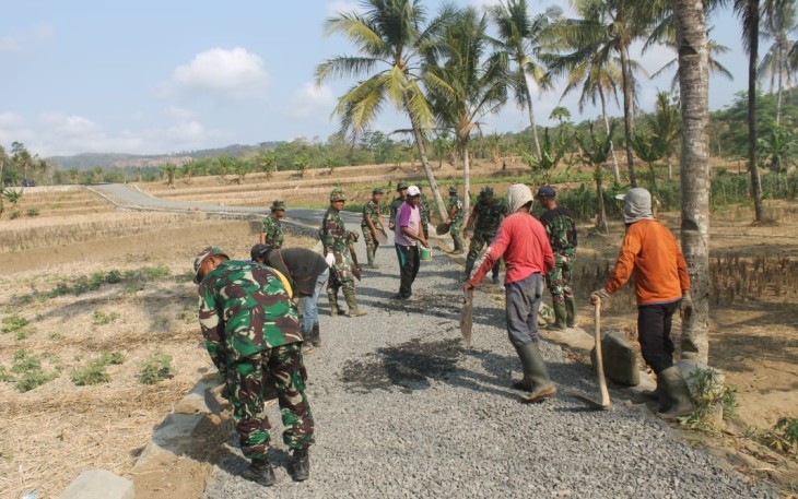 Warga Bersama Satgas TMMD Meratakan Batu Seplit 