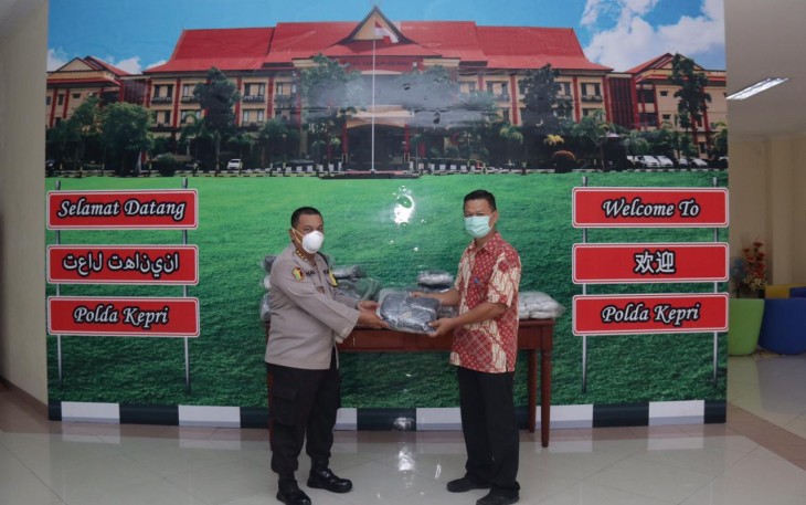 Kabid Dokkes Polda Kepri Kombes Pol dr Mohammad Haris MARS menerima bantuan masker dari Benny Taufik perwakilan UPB