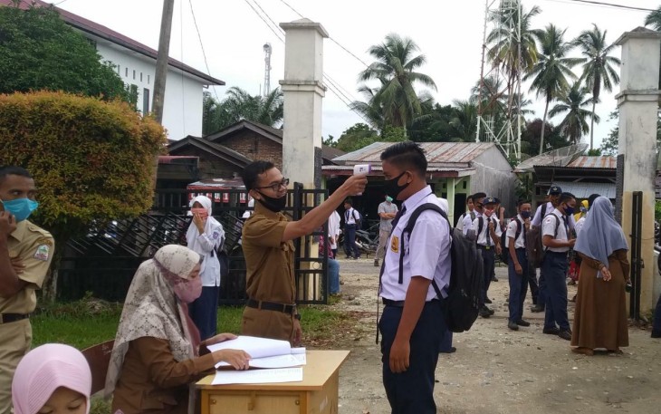 Salah seorang siswa sekolah di Aceh Singkil saat menjalani tes suhu badan.