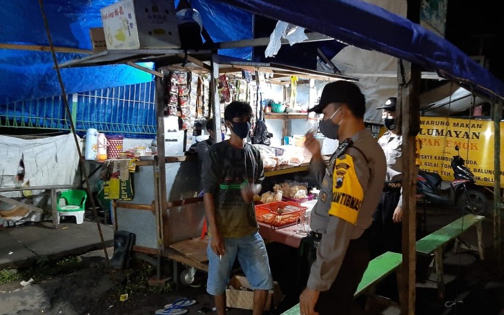 Bhabinkamtibmas Polsek Limpung Polres Batang Polda Jawa Tengah Bripka Nurhasim menyambangi pedagang kaki lima yang berjualan malam hari di sekitar alun-alun Limpung, Minggu ( 8/11/2020 ) 