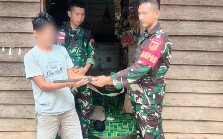Danpos Kampung Jasa Sertu Taufiqillah saat menerima senjata api rakitan warga