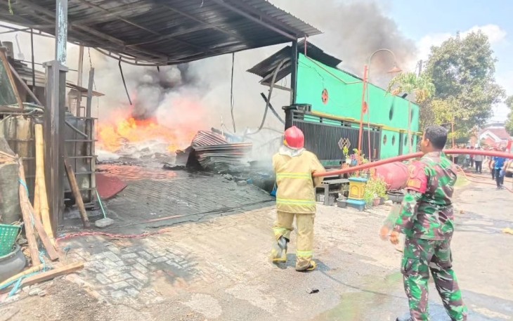 Babinsa Koramil Balerejo saat Bantu Padamkan Kebakaran Gudang Produksi Ban Vulkanisir di Desa Garon