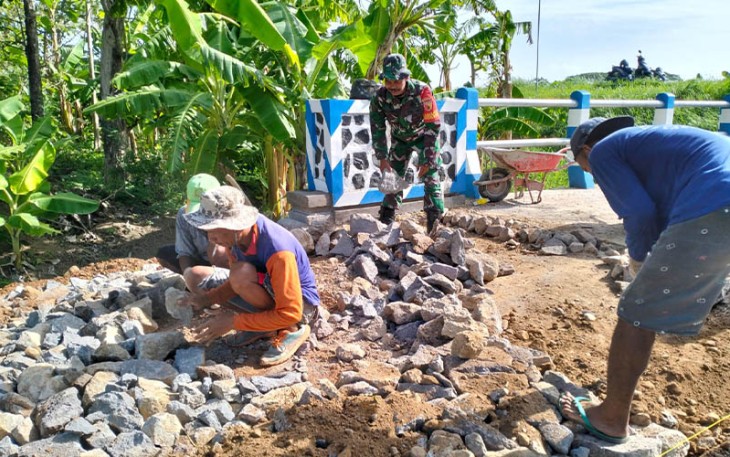 Babinsa Koramil Sawahan saat Bantu Pengerasan Jalan di Wilayah Binaan