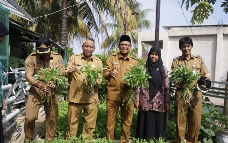 Wakil Wali Kota Depok, Imam Budi Hartono (tengah) bersama Kepala DKUM Depok, Mohamad Thamrin (kedua dari kiri), Plt. Camat Tapos, Tito Ahmad Riyadi (kiri) dan Lurah Cilangkap, Teguh Santoso (kanan) memanen kangkung di lahan KWT Wita Baskara lokus P2WKSS, RW 20 Kelurahan Cilangkap, Kecamatan Tapos, Senin (09/09/24).