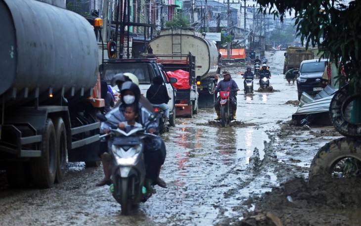 Sejumlah pengendara melintas jalan yang tergenang banjir di Bukit Tempurung, Kota Kuala Simpang, Kabupaten Aceh Tamiang, Provinsi Aceh, Jumat (9/1)