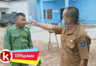 Kades Beringin Jaya saat melakukan cek suhu tubuh ke salah satu anggota Linmas