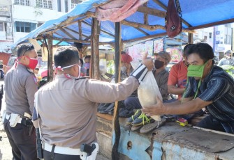 Polisi Bagikan Beras Kepada Masyarakat Kecil