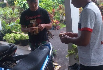 Personil satgas TMMD ke-111 kodim 1310/Bitung saat komsos bersama warga sambil menikmati segelas kopi susu