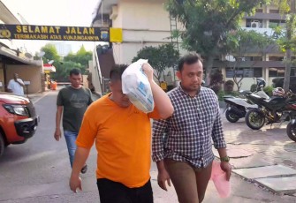 Tersangka (kenakan baju orange) saat diamankan petugas
