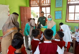 Babinsa Desa Singgit Kopda Andri Styawan anggota Koramil Tipe B 0807/11 Bandung bersama Bhabinkamtibmas mendampingi tenaga kesehatan dari Puskesmas melaksanakan kegiatan Sub Pekan Imunisasi Nasional (SubPIN) POLIO di SDN 1 Singgit Desa Singgit Kecamatan Bandung Kabupaten Tulungagung Jawa Timur, Senin (15/01/2024)