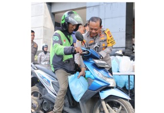Polda Metro Jaya Bagikan Helm dan Sembako untuk Pengemudi Ojek Online